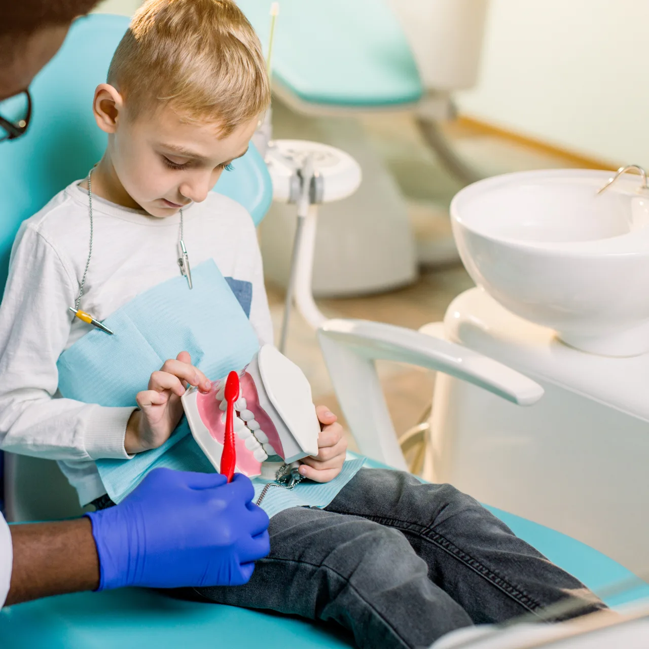 Child smiling in a dental chair