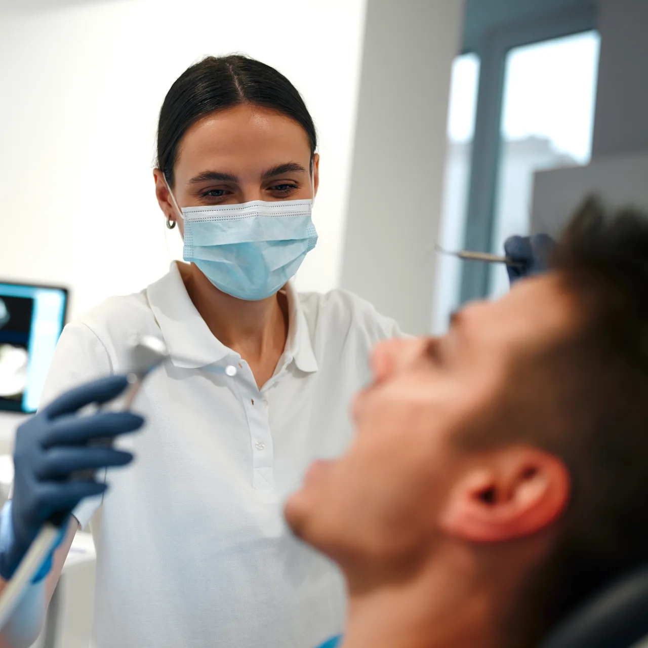 Dentist examining a patient during a dental treatment visit